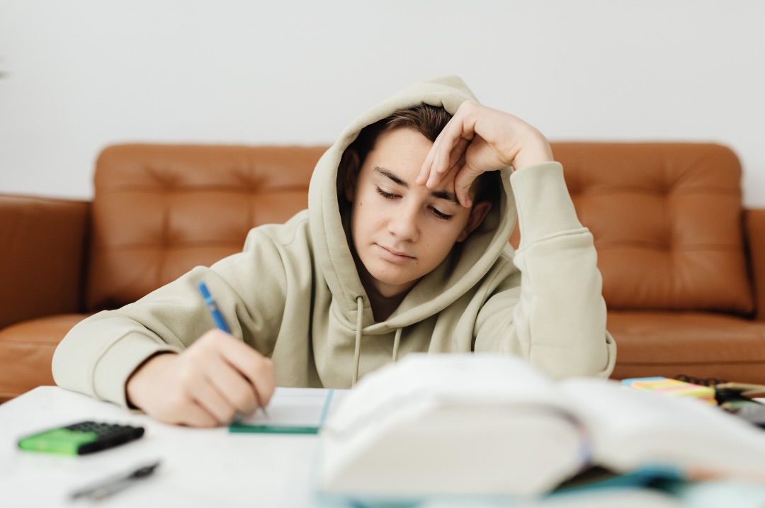 勉強をしながら悩んでいる男性